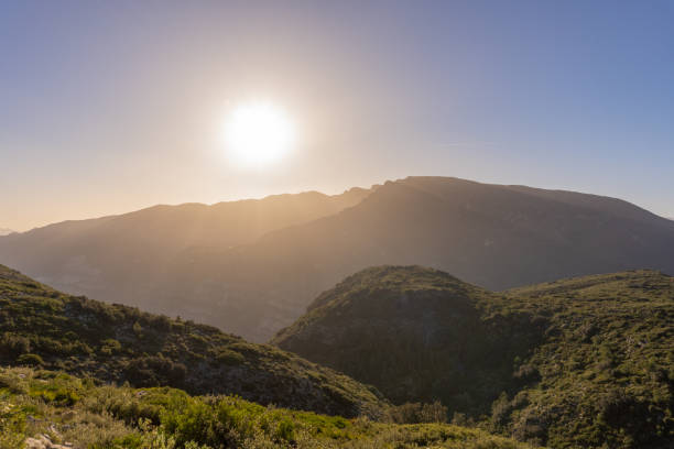 istock The sun rises over the mountains on a morning with a clear, cloudless sky 1453586831