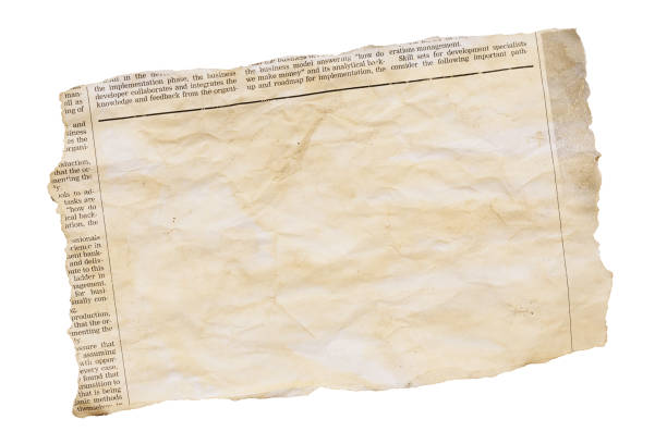Distressed, yellowed, stained cutting from a newspaper, isolated on white, with plenty of space for your copy Wrinkled piece of paper torn from a simulated newspaper, designed by the photographer and free of design copyright. Large blank area in which to insert your copy. Isolated on white. torn paper effect stock pictures, royalty-free photos & images