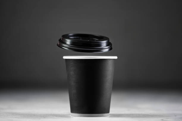 istock Paper cup of coffee on dark background 1453590391