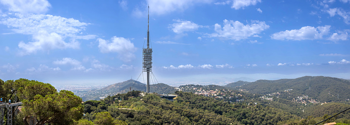 large astronomical radio telescope on the seashore against the backdrop of mountains