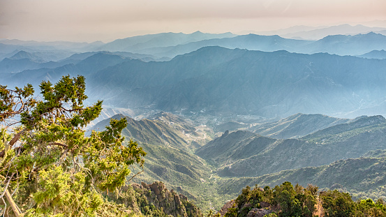 The view of a foggy valley in the early hours of the morning in the assure region of Saudi Arabia