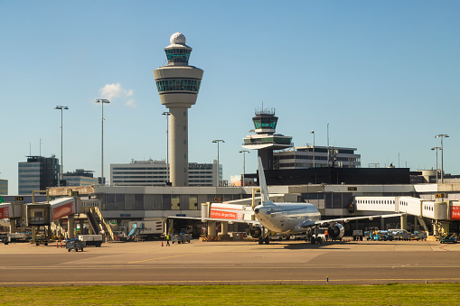 Amsterdam, Netherlands, June 9, 2022; Airplane at Schiphol airport with the control tower in the background.