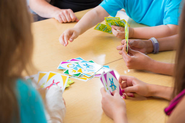 istock School children playing card game 1453595066