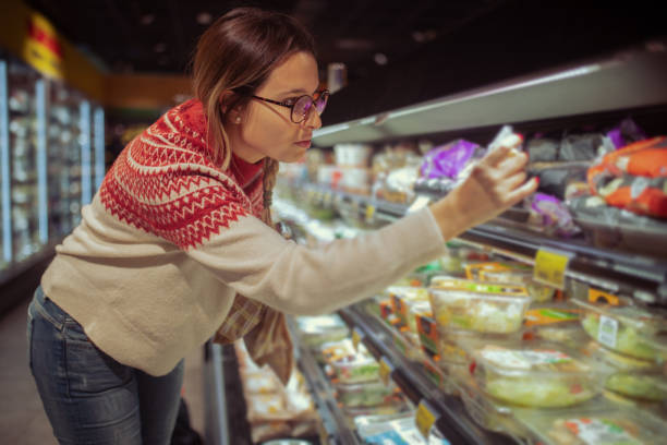 istock Female in a sweater shops at a grocery store 1453596808