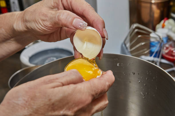 istock Chef separates the yolk from the protein to make the pie 1453596872