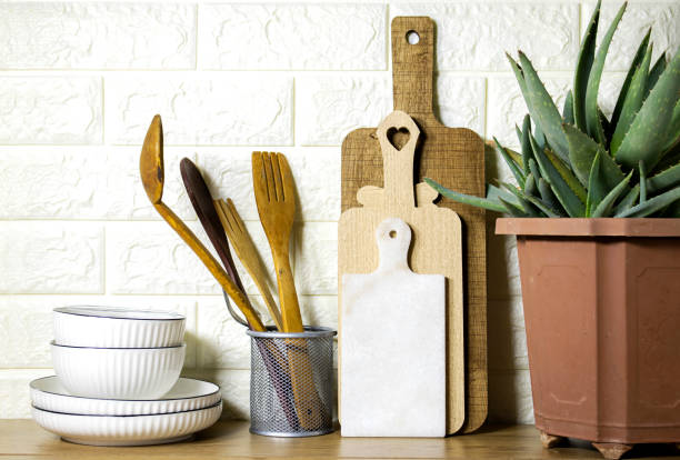 istock Kitchen utensils background and houseplant aloe vera, home kitchen decor concept, front view 1453597033