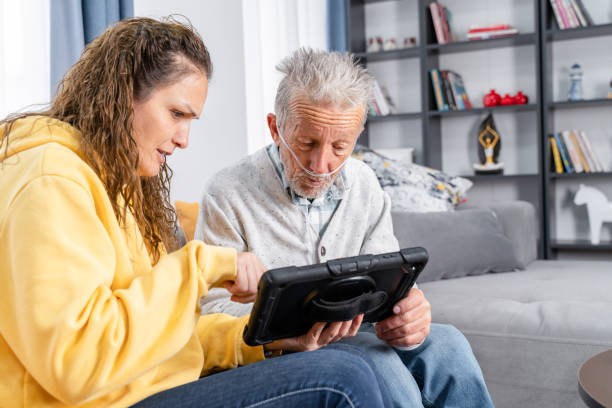 istock Senior man takes help in digital tablet from a young woman 1453597629