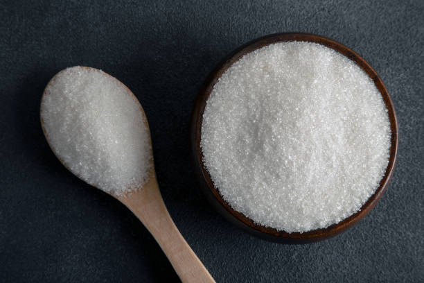 istock Granulated sugar in bowl on dark background,directly above 1453597768