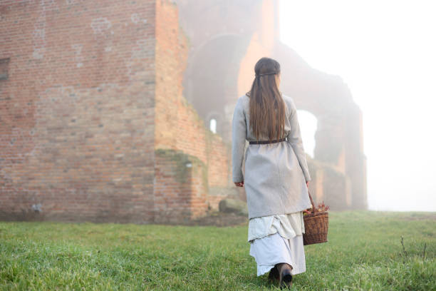 Young woman posing in a period costume in a medieval castle. About 25 years old, Caucasian brunette.