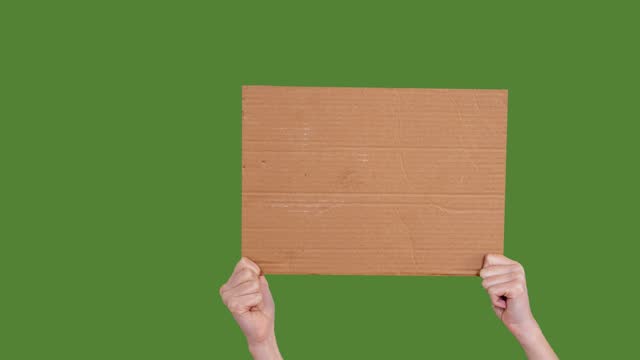 Hand holding cardboard box on chroma key background