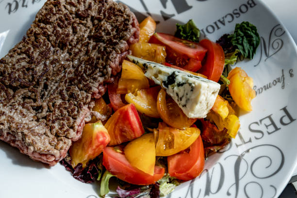 plate of minced steak with salad and french cheese