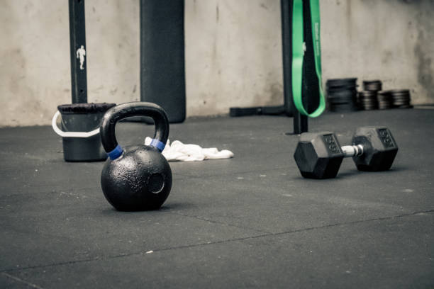 istock kettle bells and dumbells on a floor 1453600559