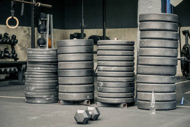 istock pile of weights on a gym floor 1453600562