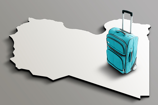 Blue suitcase on blank 3d map of Libya. Copy space. No people. Horizontal orientation.