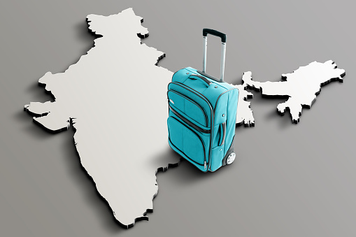Blue suitcase on blank 3d map of India. Copy space. No people. Horizontal orientation.
