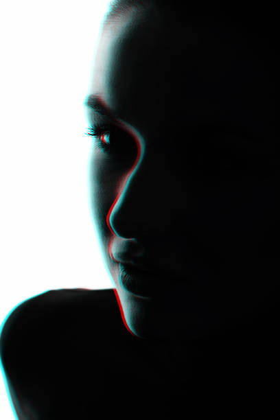 istock Part beautiful woman face silhouette covered in shadow in RGB color split effect style 1453603568