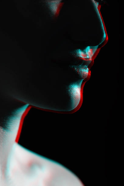 istock Part beautiful woman face silhouette covered in shadow in RGB color split effect style 1453603571