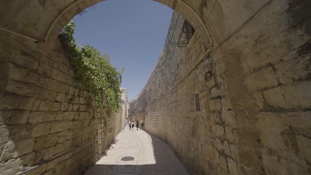 People Walking Through Stone Archway Within The Western Wall In Old City Of Jerusalem In Israel. - POV