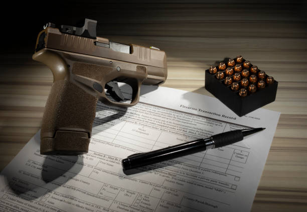 istock Form to purchase a gun with pistol and cartridges 1453605787