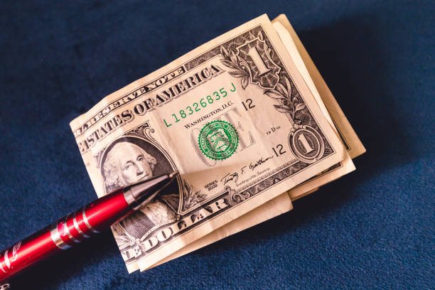 istock United States one dollar bills on a blue sofa. 1453606800