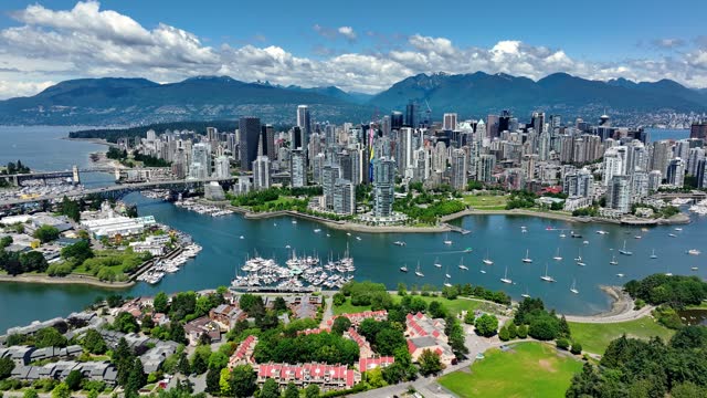 False Creek And Downtown Vancouver In British Columbia, Canada On A Sunny Day. aerial pullback