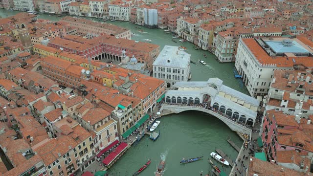 4K Aerial of San Marco, the Rialto Bridge, and the canals in Venice, Italy on a cloudy day.