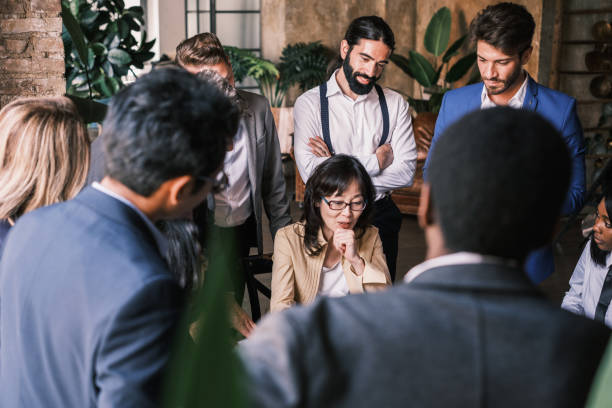 istock Woman with Asian features explaining to her workers how to deal with statistical data 1453607631