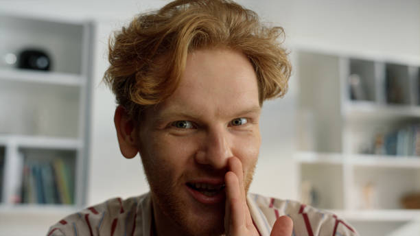 istock Happy guy enjoy conference at home closeup. Happy ginger husband telling secrets 1453608447