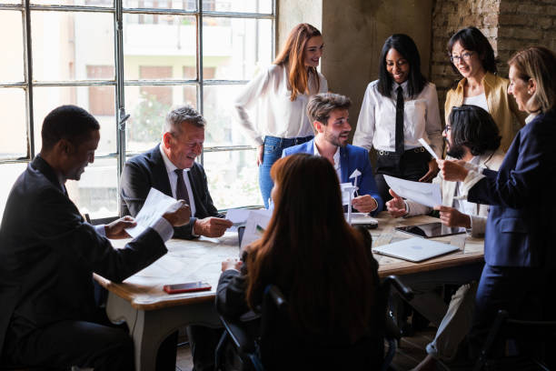 istock group of workers meeting in company board room discussing and making decisions 1453608867