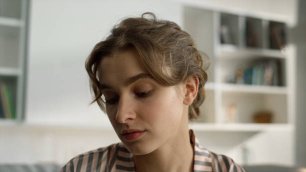 istock Student watching webinar home closeup. Serious girl look web camera in morning. 1453609003