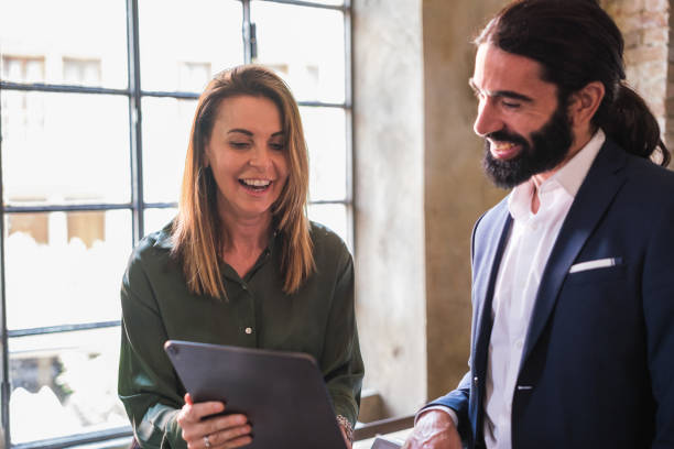 istock Businesswoman explaining the work project to her partner with electronic devices 1453609170