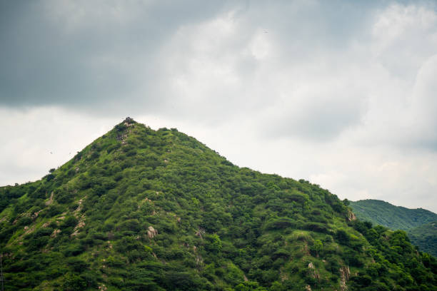 istock Aravalli range in jaipur rajasthan with small hills mountains covered in green trees under monsoon clouds 1453609440