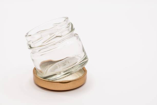 istock Mini empty clear jam jar with bronze coloured screw on lid 1453610603