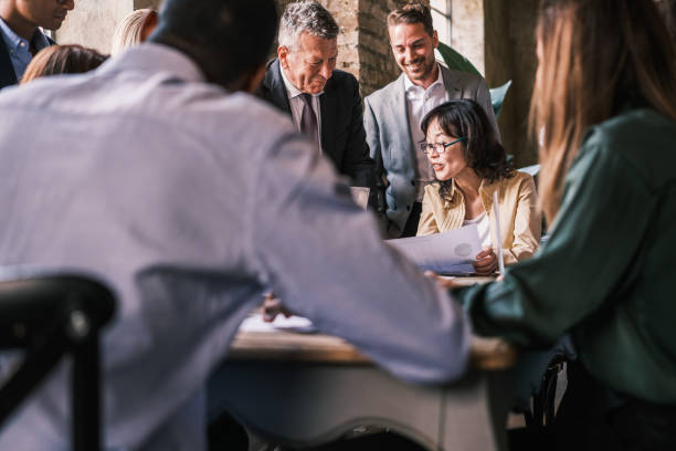 istock Group of workers gathered to analyze the evolution graphs of the company 1453611055