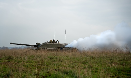 army battle tanks in action on a military combat exercise