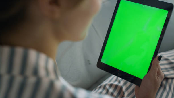 istock Girl calling chroma tablet closeup. Unrecognized woman talking friend on sofa. 1453615596