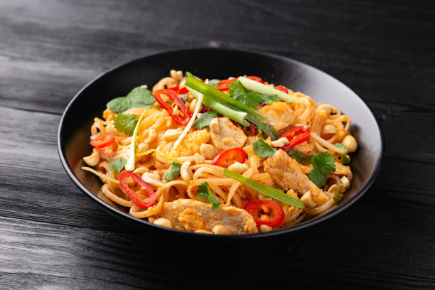 istock Chicken Pad Thai with eggs, bean sprouts, peanuts and spring onion 1453618528