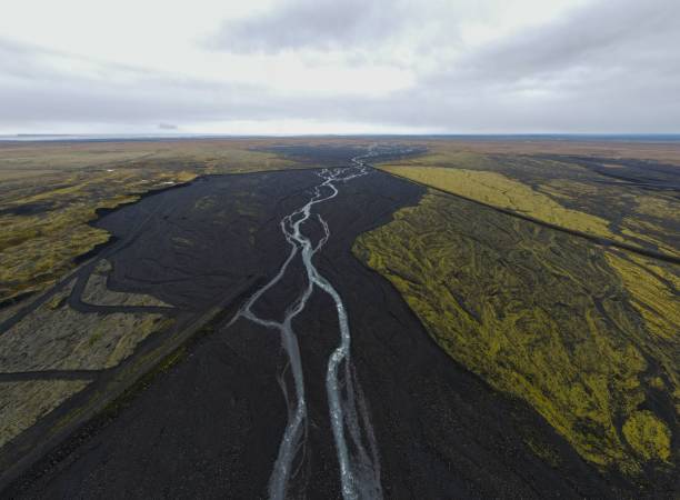 istock Aerial view of river surrounded by greenery fields 1453621174