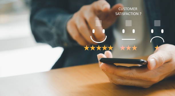 istock Selective focus at finger of business man while point finger to choose feedback on excellent customer service with five star score with smile. Service evaluation concept with futuristic icon. 1453621936