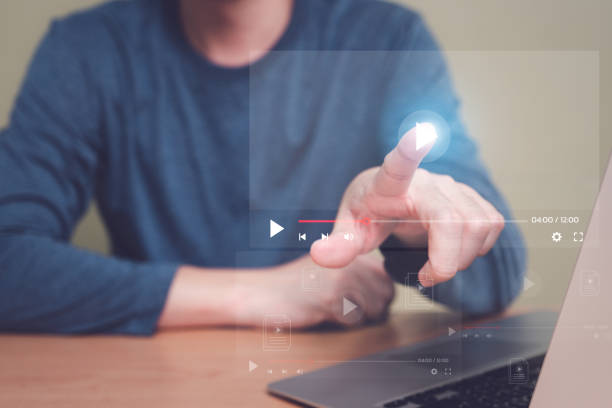 istock Selective focus at finger that push on press play button for start online entertainment for on demand video streaming service that online over internet which include movie or music. 1453626645
