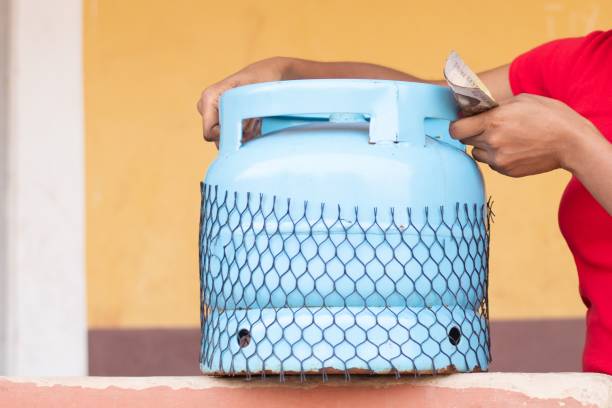 istock holding money and lifting a gas cylinder 1453628651