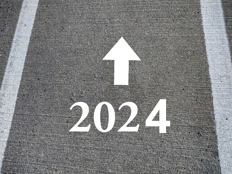Direction 2024 written on asphalt road. New Year 2024 concept