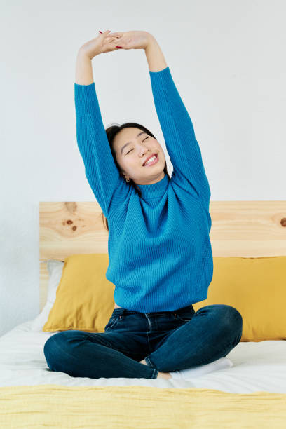 istock Young woman doing stretching exercises 1453632771