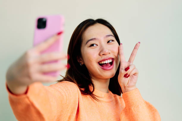istock Cheerful Asian woman taking a selfie 1453633216