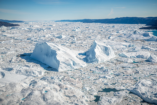 Aerial view of Massive Iceberg floating in Ilulissat Icefjord, Greenland. The picture has been taken from a plane