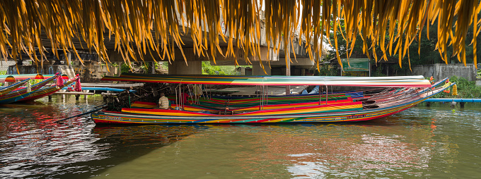 Bangkok, Thailand. November 4, 2022; Taling Chan Floating Market and traditional river cruise tourist boats. It's tourist season time.