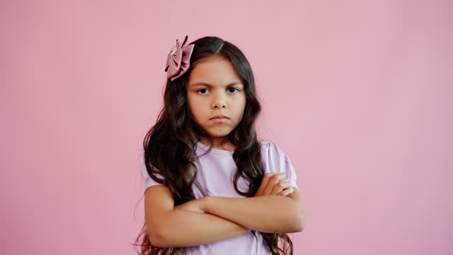 Angry girl on a pink background