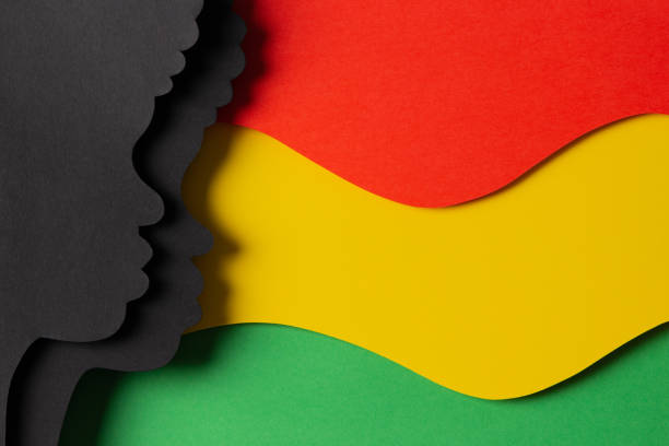 istock Black History Month color background. African Americans history celebration. Abstract geometric red, yellow, green color background with black paper cut people silhouette. Top view 1453638603