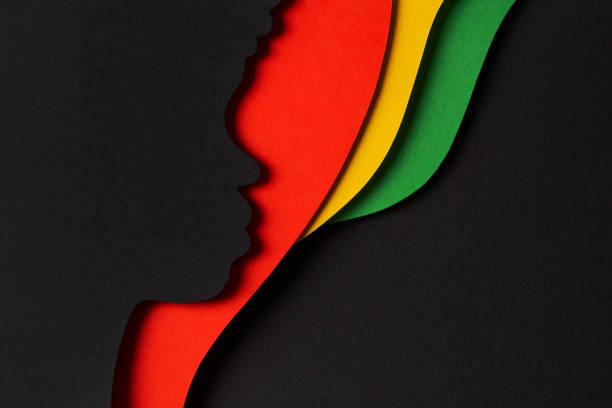 istock Black History Month color background. African Americans history celebration. Abstract geometric red, yellow, green color background with black paper cut people silhouette. Top view 1453638668