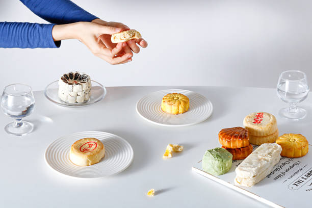 istock Person sitting at a coffee table with various types of desserts on a white background 1453641709